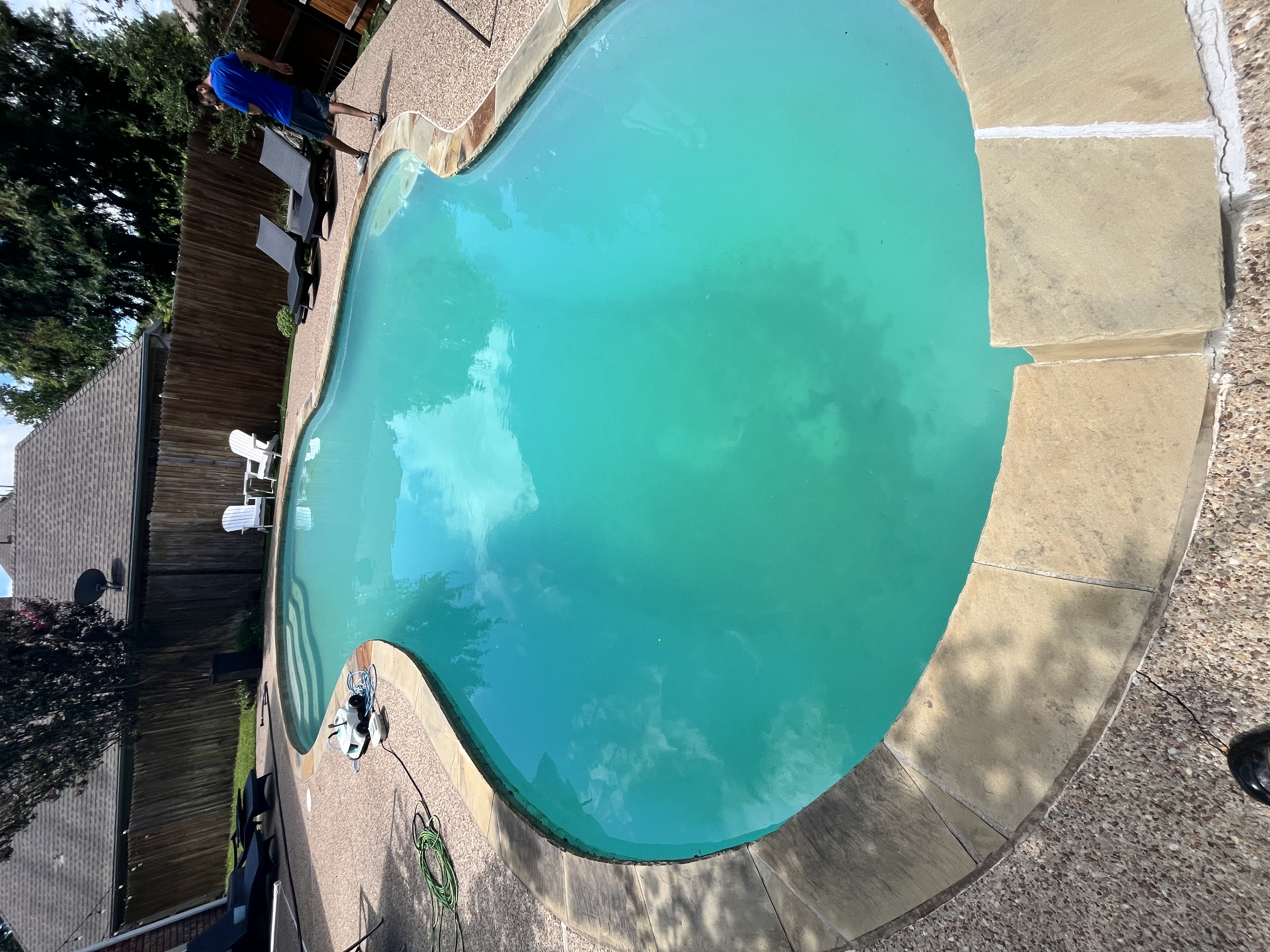 Cloudy backyard pool in DeSoto TX before professional pool water treatment, cleaning, and chemistry recovery